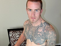Muscled hunk Caleb with pretty eyes stares at the  camera